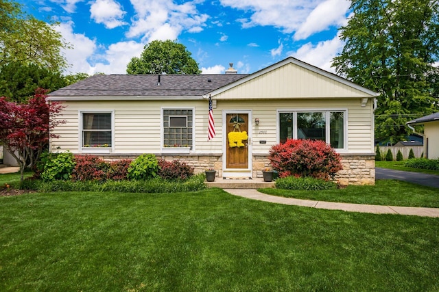 2380 Cranford Rd, Upper Arlington, OH 43221 - view of front of home with a front lawn, stone siding, and roof with shingles