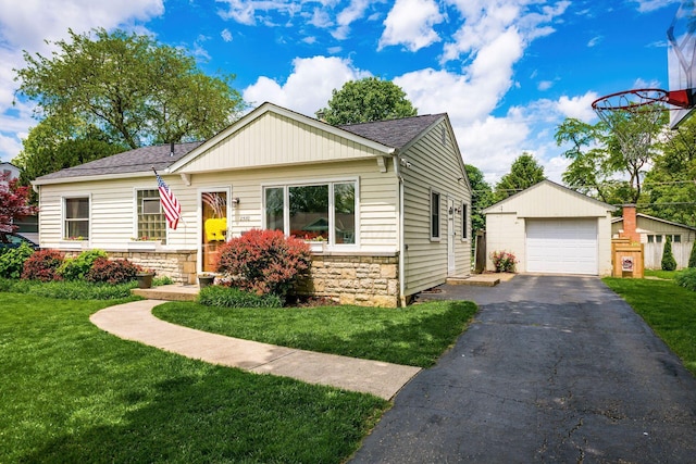 2380 Cranford Rd, Upper Arlington, OH 43221 - ranch-style home featuring a detached garage, stone siding, an outbuilding, a shingled roof, and a front lawn