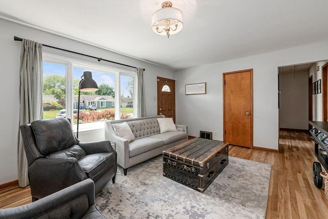 2380 Cranford Rd, Upper Arlington, OH 43221 - living room featuring light wood finished floors, attic access, a chandelier, and baseboards