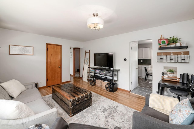 2380 Cranford Rd, Upper Arlington, OH 43221 - living area featuring wood finished floors, baseboards, and a chandelier
