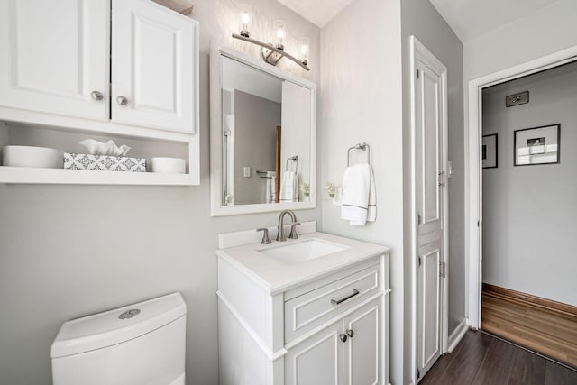 2380 Cranford Rd, Upper Arlington, OH 43221 - bathroom featuring vanity, toilet, wood finished floors, and baseboards