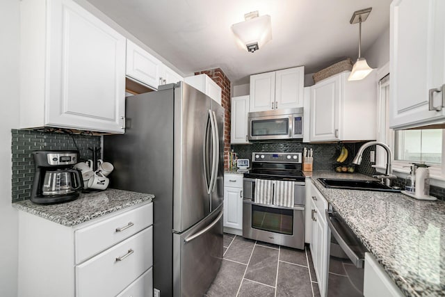 2380 Cranford Rd, Upper Arlington, OH 43221 - kitchen with appliances with stainless steel finishes, a sink, decorative backsplash, and white cabinetry