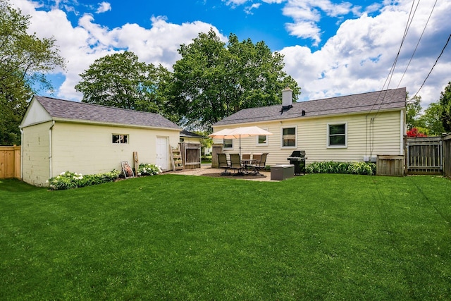 2380 Cranford Rd, Upper Arlington, OH 43221 - rear view of property featuring a chimney, a patio area, an outbuilding, and a shingled roof