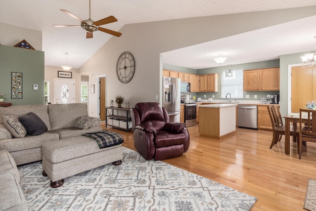 4989 Edgeley Dr, Hilliard, OH 43026 - living area featuring light wood finished floors, ceiling fan, a chandelier, and high vaulted ceiling