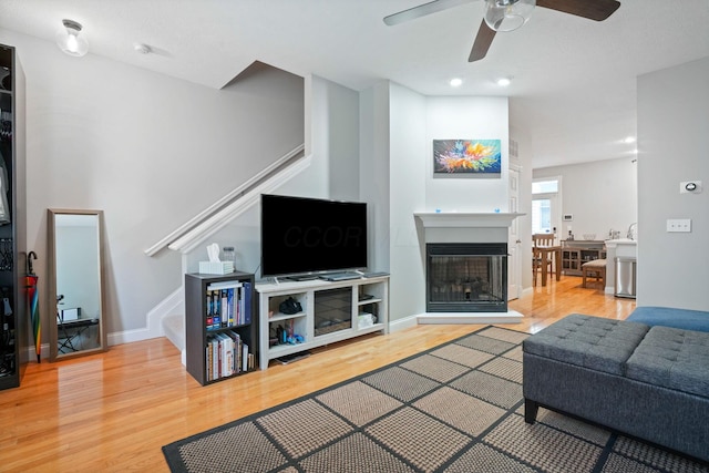 963 Delaware Ave, Columbus, OH 43201 - living area featuring stairway, wood finished floors, a ceiling fan, and a glass covered fireplace