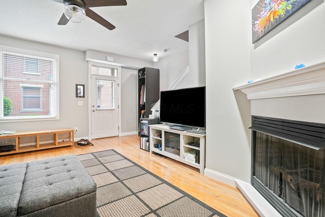 963 Delaware Ave, Columbus, OH 43201 - living area featuring light wood finished floors, baseboards, ceiling fan, and a fireplace