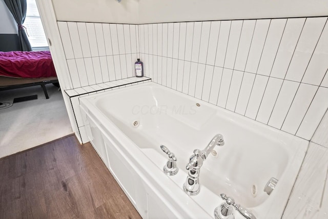 963 Delaware Ave, Columbus, OH 43201 - ensuite bathroom featuring a whirlpool tub and wood finished floors