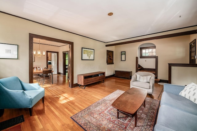 431 Glen Echo Cir, Columbus, OH 43202 - living area featuring a chandelier, light wood-style floors, arched walkways, and baseboards