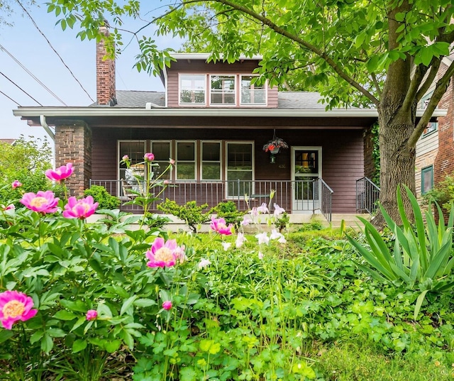 431 Glen Echo Cir, Columbus, OH 43202 - view of front of house featuring a porch, a chimney, and a shingled roof