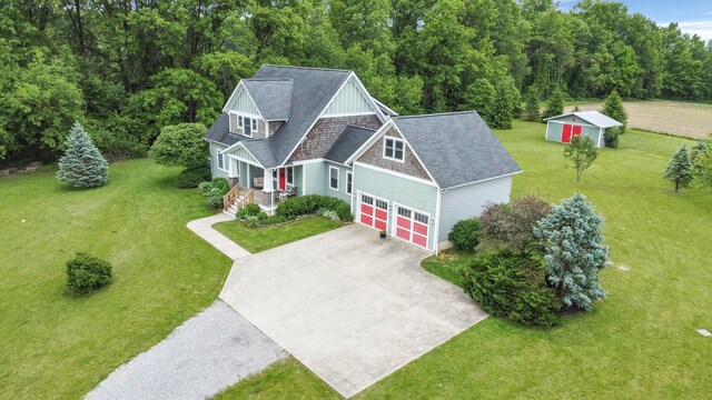 14980 Robins Rd, Johnstown, OH 43031 - view of front of property with a front yard, covered porch, driveway, and roof with shingles
