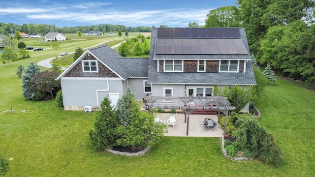 14980 Robins Rd, Johnstown, OH 43031 - rear view of house featuring a patio, solar panels, a yard, and roof with shingles