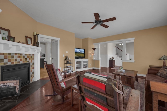 14980 Robins Rd, Johnstown, OH 43031 - living area with wood finished floors, a tiled fireplace, a ceiling fan, stairway, and baseboards