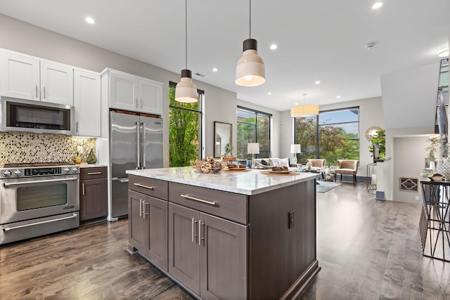 123 Aston Row Ln, Columbus, OH 43201 - kitchen with appliances with stainless steel finishes, recessed lighting, dark wood-type flooring, backsplash, and white cabinets