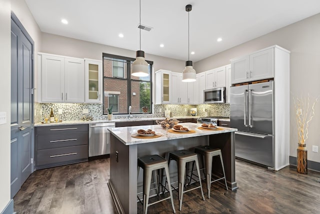 123 Aston Row Ln, Columbus, OH 43201 - kitchen with appliances with stainless steel finishes, dark wood-style flooring, glass insert cabinets, backsplash, and recessed lighting