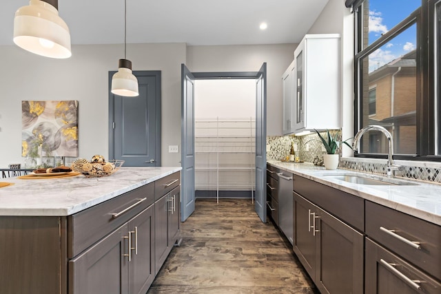 123 Aston Row Ln, Columbus, OH 43201 - kitchen with dishwasher, a sink, dark wood-style flooring, light stone counters, and recessed lighting
