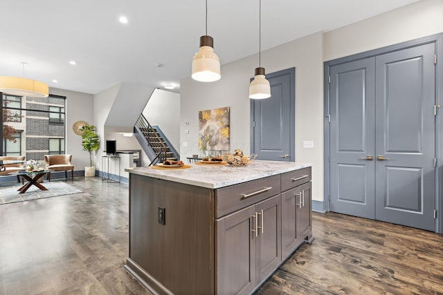 123 Aston Row Ln, Columbus, OH 43201 - kitchen with dark wood-type flooring, pendant lighting, a kitchen island, light stone countertops, and recessed lighting
