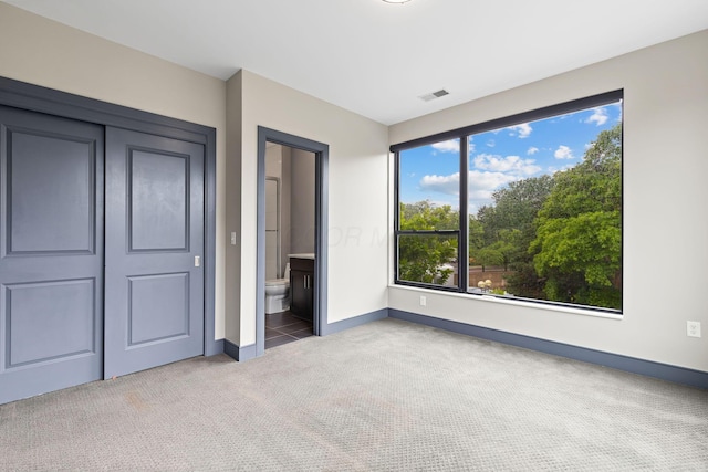 123 Aston Row Ln, Columbus, OH 43201 - unfurnished bedroom with carpet, baseboards, and connected bathroom