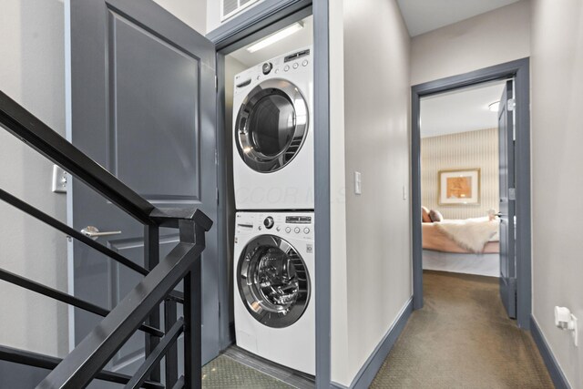 123 Aston Row Ln, Columbus, OH 43201 - washroom with estacked washer and dryer, carpet floors, and baseboards