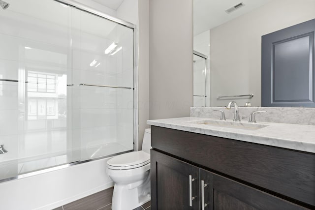 123 Aston Row Ln, Columbus, OH 43201 - bathroom with vanity, enclosed tub / shower combo, toilet, and wood finished floors