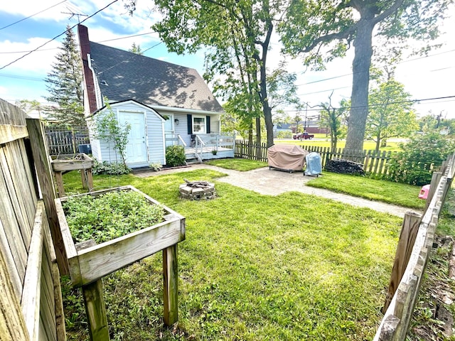 908 W 5th St, Marysville, OH 43040 - view of yard featuring an outdoor fire pit, a wooden deck, and a garden