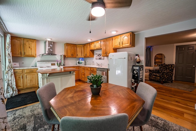 2719 Sulphur Lick Rd, Chillicothe, OH 45601 - kitchen featuring refrigerator, wall chimney range hood, stove, a sink, and ceiling fan