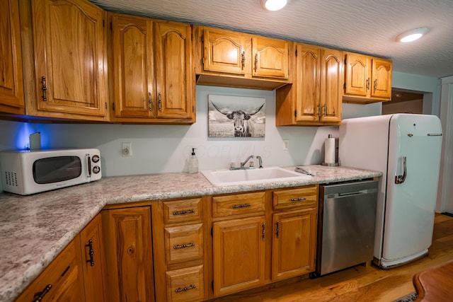 2719 Sulphur Lick Rd, Chillicothe, OH 45601 - kitchen featuring white appliances, a sink, light countertops, and brown cabinetry