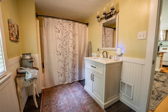 2719 Sulphur Lick Rd, Chillicothe, OH 45601 - bathroom featuring wainscoting, vanity, and wood finished floors