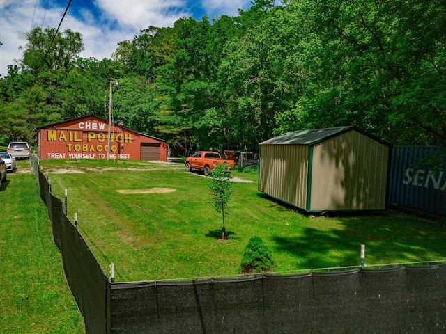 2719 Sulphur Lick Rd, Chillicothe, OH 45601 - view of yard with an outbuilding, a detached garage, a view of trees, and driveway