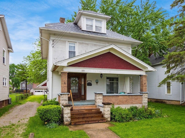 251 Summit St, Marion, OH 43302 - american foursquare style home featuring covered porch, a front yard, a chimney, brick siding, and roof with shingles