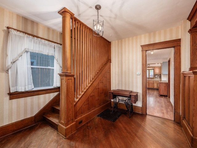 251 Summit St, Marion, OH 43302 - stairway featuring wallpapered walls, wood finished floors, a chandelier, and baseboards