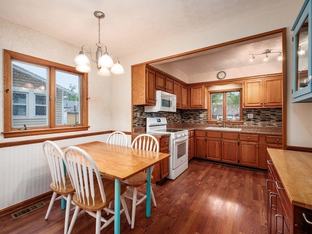 251 Summit St, Marion, OH 43302 - kitchen with white appliances, a sink, brown cabinetry, and dark wood-style floors