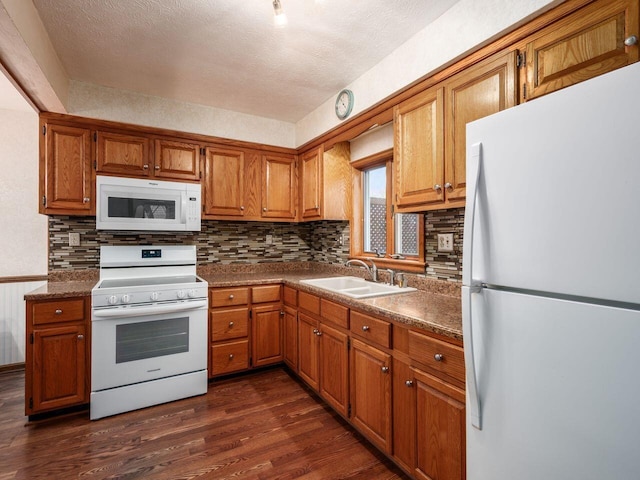 251 Summit St, Marion, OH 43302 - kitchen featuring white appliances, a sink, dark wood-style floors, tasteful backsplash, and a textured ceiling