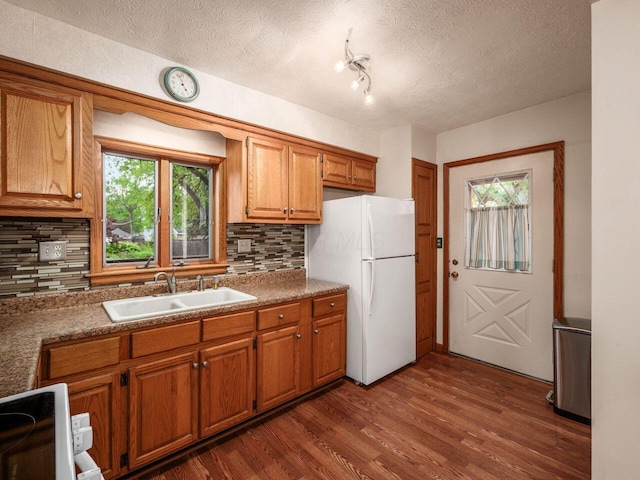 251 Summit St, Marion, OH 43302 - kitchen with a sink, freestanding refrigerator, backsplash, healthy amount of natural light, and a textured ceiling