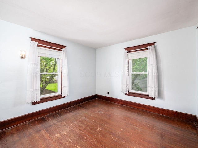 251 Summit St, Marion, OH 43302 - empty room featuring healthy amount of natural light, hardwood / wood-style floors, and baseboards