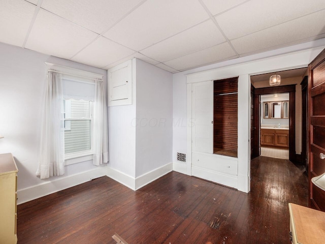 251 Summit St, Marion, OH 43302 - unfurnished bedroom featuring baseboards, a drop ceiling, hardwood / wood-style flooring, and a sink