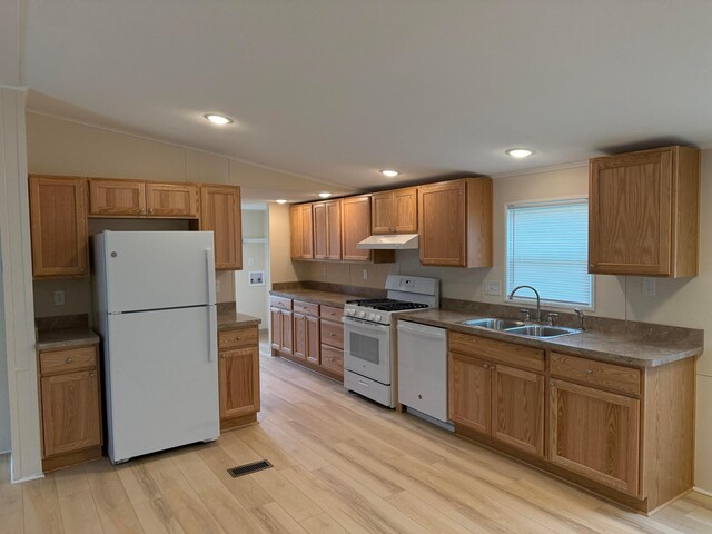 45 Winter Pine Dr, Delaware, OH 43015 - kitchen with white appliances, a sink, under cabinet range hood, dark countertops, and light wood-style floors