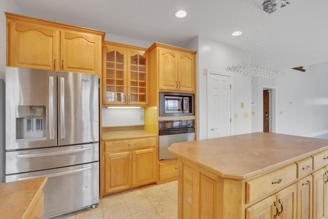 40455 Cone Rd, Albany, OH 45710 - kitchen with stainless steel appliances, glass insert cabinets, light countertops, recessed lighting, and a kitchen island