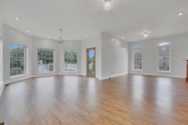 40455 Cone Rd, Albany, OH 45710 - unfurnished living room featuring a chandelier, wood finished floors, and recessed lighting