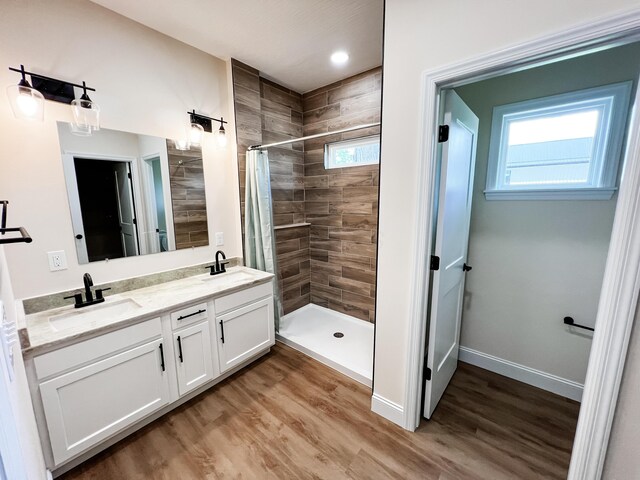 13541 Queen Rd NE, Thornville, OH 43076 - full bath featuring a tile shower, double vanity, wood finished floors, baseboards, and recessed lighting