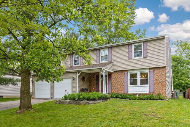 998 Timberbank Dr, Westerville, OH 43081 - view of front of home with concrete driveway, a front yard, brick siding, and an attached garage