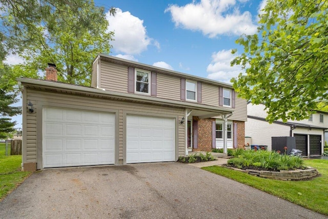 998 Timberbank Dr, Westerville, OH 43081 - traditional home with driveway, a chimney, a garage, and brick siding