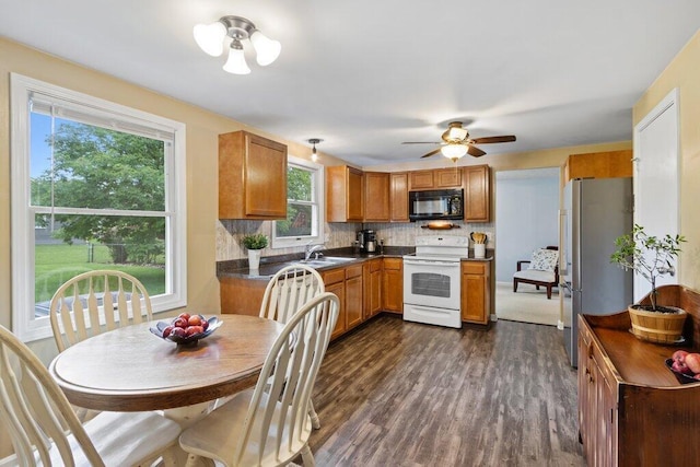 998 Timberbank Dr, Westerville, OH 43081 - kitchen with white electric range oven, black microwave, freestanding refrigerator, dark countertops, and a sink