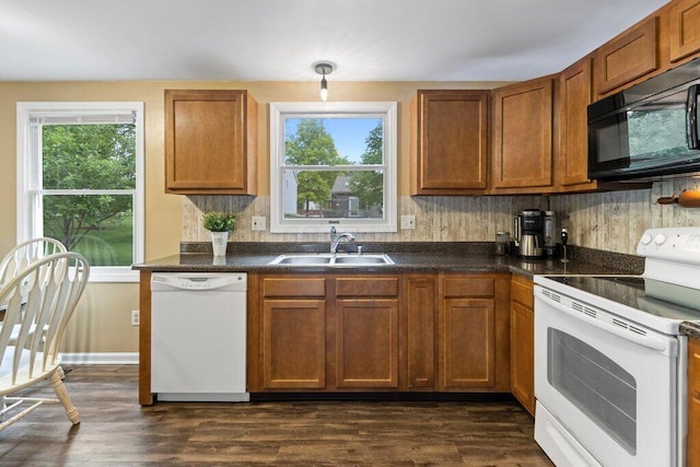 998 Timberbank Dr, Westerville, OH 43081 - kitchen featuring white appliances, dark countertops, a sink, tasteful backsplash, and brown cabinetry