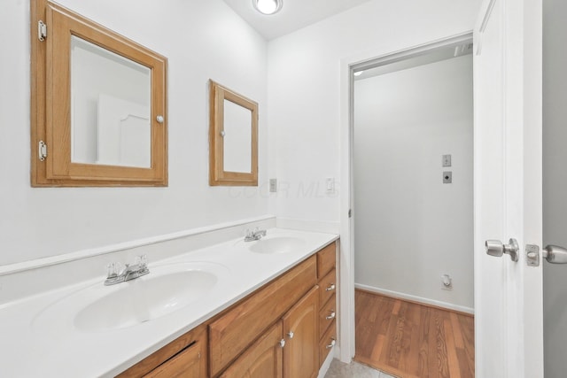 385 Taylor Blair Rd, West Jefferson, OH 43162 - full bathroom featuring double vanity, wood finished floors, and baseboards
