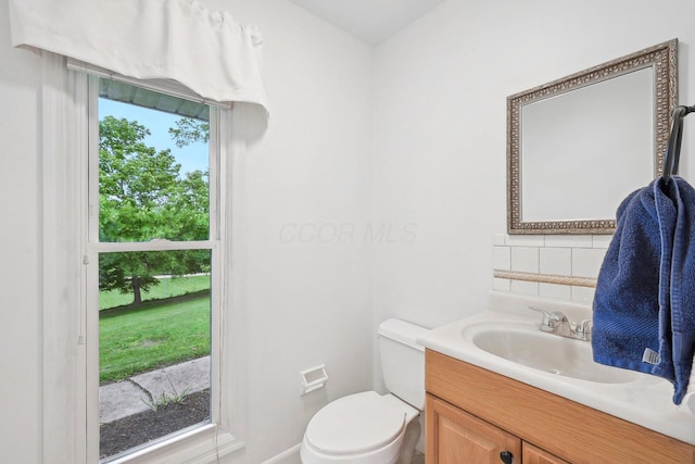 385 Taylor Blair Rd, West Jefferson, OH 43162 - half bath with vanity, toilet, tasteful backsplash, and baseboards