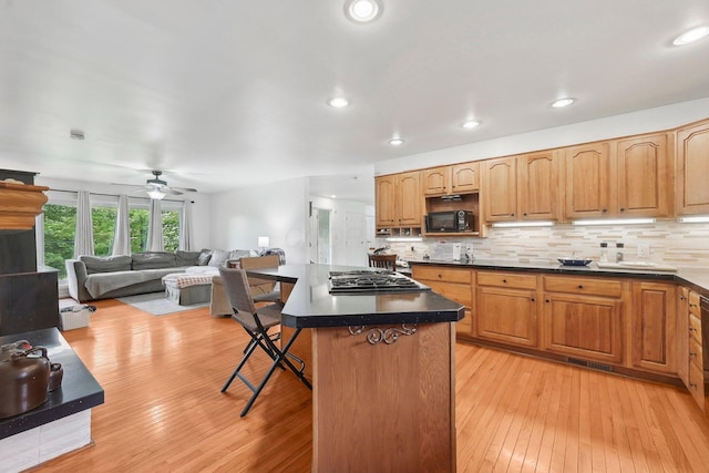 385 Taylor Blair Rd, West Jefferson, OH 43162 - kitchen with black microwave, a kitchen breakfast bar, light wood-type flooring, a ceiling fan, and recessed lighting