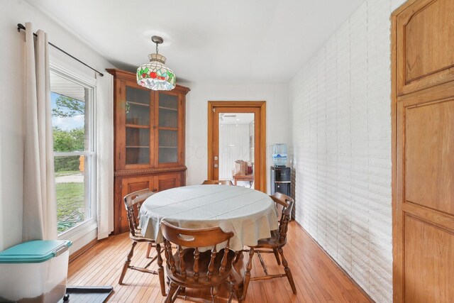 385 Taylor Blair Rd, West Jefferson, OH 43162 - dining room featuring plenty of natural light, light wood-style flooring, and brick wall