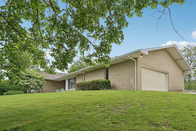 385 Taylor Blair Rd, West Jefferson, OH 43162 - view of side of property featuring brick siding, a lawn, and an attached garage