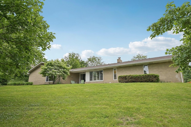 385 Taylor Blair Rd, West Jefferson, OH 43162 - back of house with a chimney and a yard