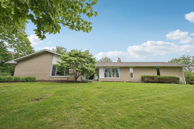 385 Taylor Blair Rd, West Jefferson, OH 43162 - view of front of property featuring a front yard, a chimney, and brick siding